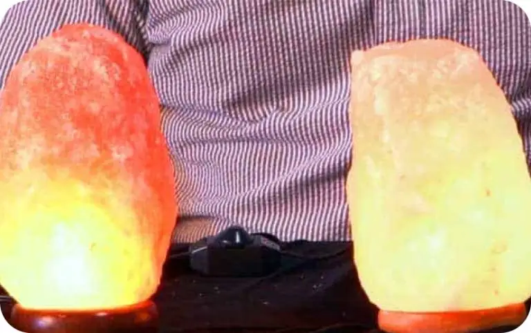 Man holding two different himalayan salt lamps