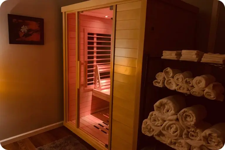 Salt cave sauna installed in a dark room with towels next to it