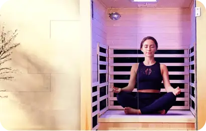 Lady sitting in a yoga position inside a sauna
